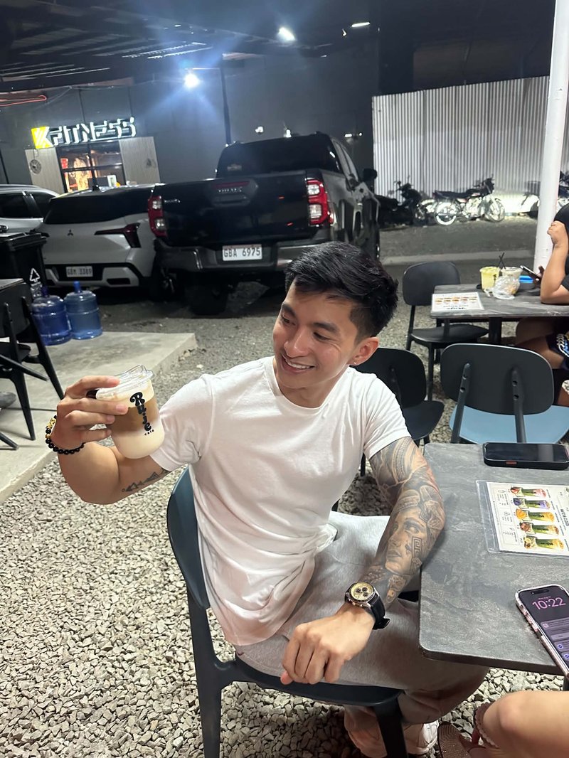 Sir Mike seated at Ruje Café with an iced drink
