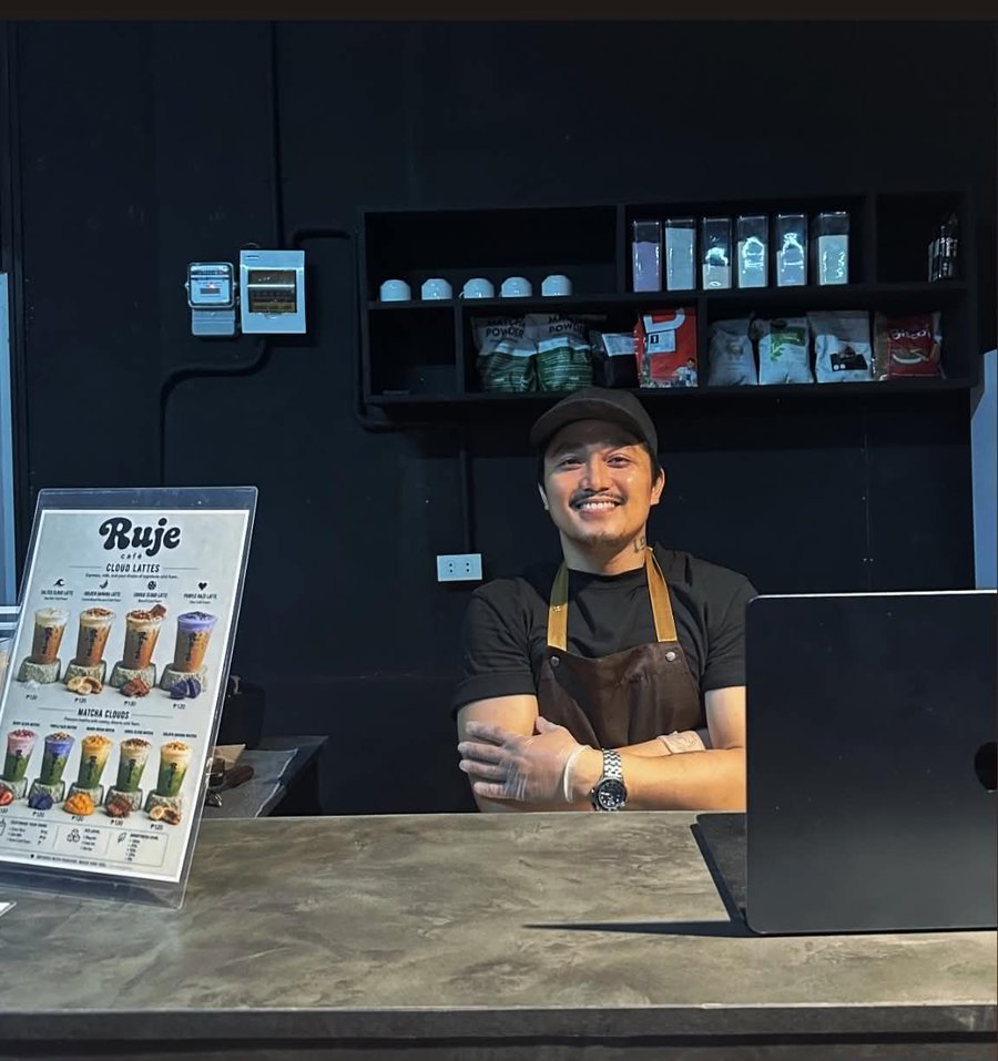 Jeff, co-owner of Ruje Café, smiling behind the counter in his apron